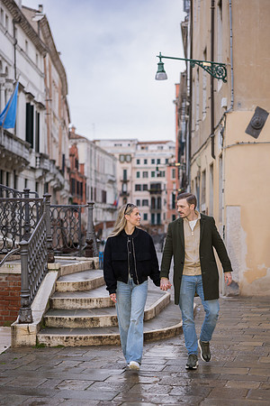 A rainy-day stroll in Venice, symbolizing their journey into marriage.