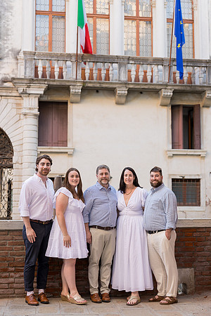 Family of five posing in front of a historic building in Venice.