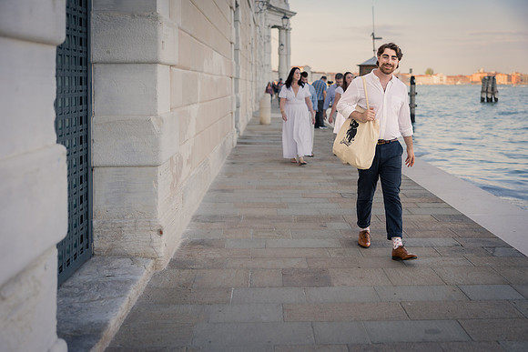 Family strolling along the Venice waterfront during summer.