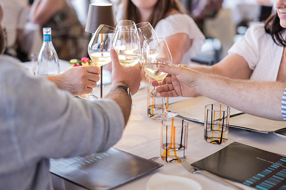 Family toasting to their summer vacation at Linea d'Ombra in Venice.