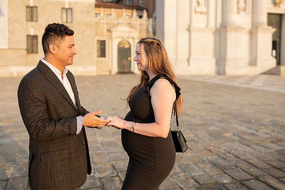 Couple laughing post-proposal by Venetian water