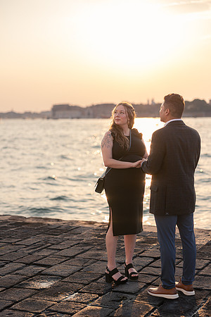 Tender moment by water during Venice sunset