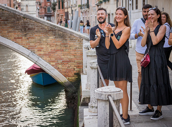 Friends cheering during a proposal at Ponte Chiodo, Venice.