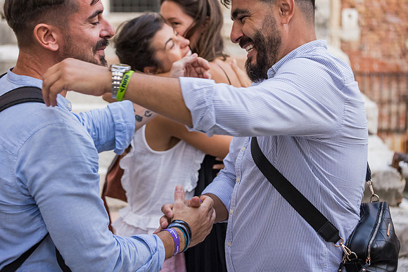 Friends celebrating proposal at Ponte Chiodo, Venice.