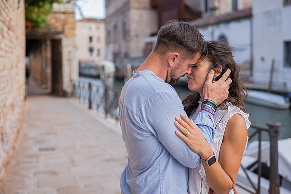 Couple embracing by the canal in Venice.