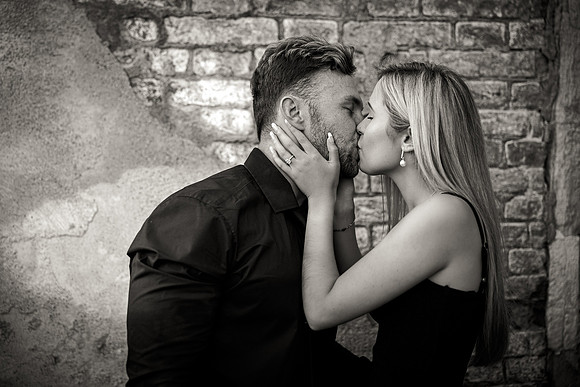 Couple embracing in golden sunset light in Venice