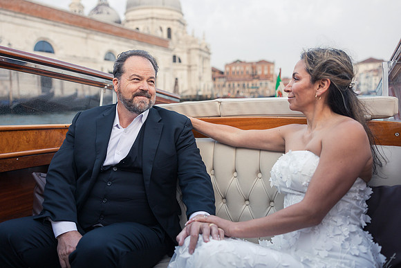Bride and groom enjoying a sunrise water taxi ride - Anniversary sunrise photoshoot in Venice.