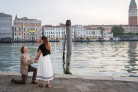 Couple celebrating engagement by the water