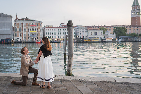 Couple celebrating engagement by the water