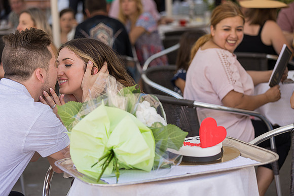Couple toasting after proposal at Café Florian