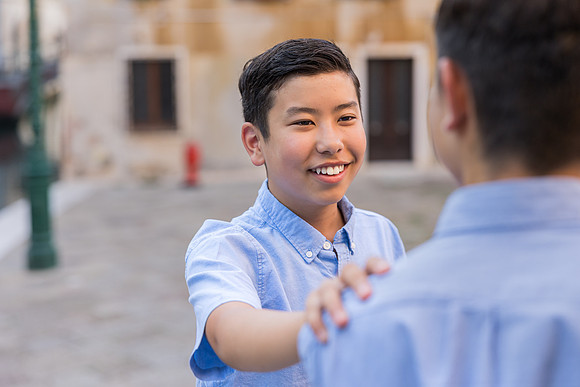 Son smiling in the streets of Venice during a candid moment in the family session.