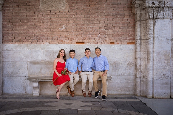 Generational family portrait on Venetian steps, capturing the bond between three generations.