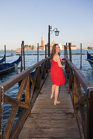 Mother's portrait on a wooden pier in Venice, with gondolas and water surrounding her.