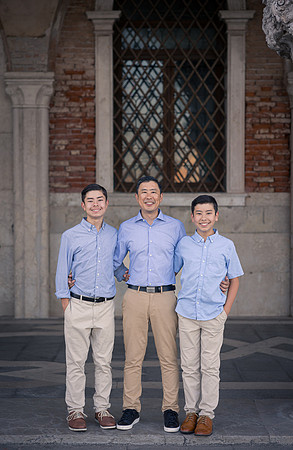 Two brothers standing together in St. Mark's Square, Venice, during their family photo session.