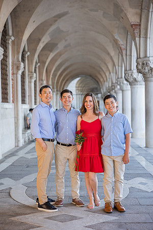 Family portrait taken under the arches of St. Mark's Square, Venice, capturing a timeless moment.