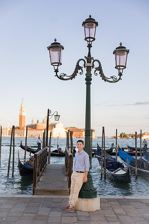 Family portrait by a Venetian lamp post at sunset, enjoying the evening colors and atmosphere.