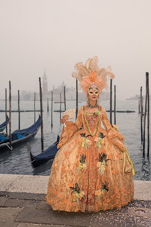 Masked guest walking through Venice streets during Carnival