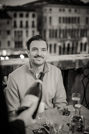 A black-and-white image of the couple, capturing their happiness in a Venetian cafe.
