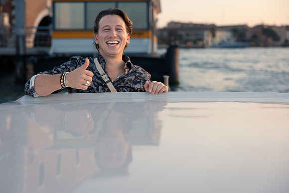 Couple celebrating in water taxi after proposal