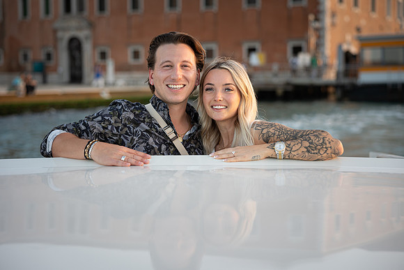 Kiss with Venetian architecture background after proposal