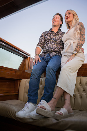 Couple enjoying water taxi ride after proposal in Venice