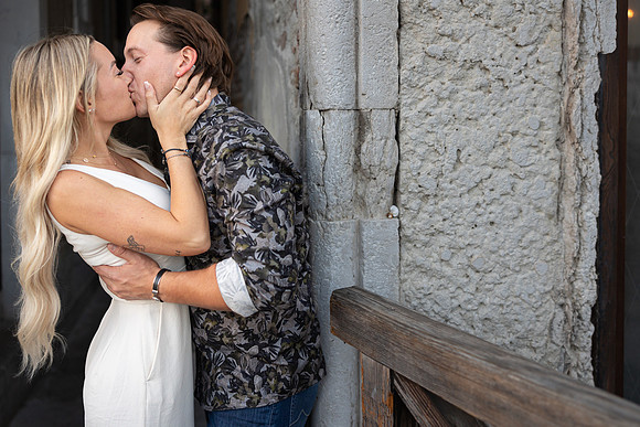 Romantic portrait under Venetian archway after proposal