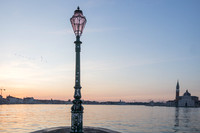 Venetian lamp post at dawn with lagoon view