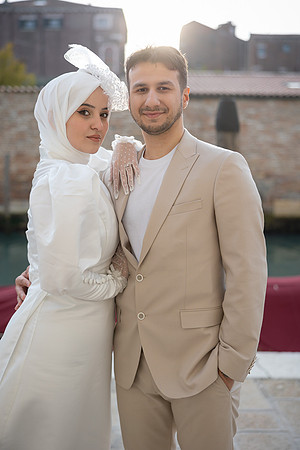 Couple posing elegantly in Venice after their engagement.