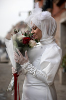 Bride-to-be holding a bouquet, posing in Venice.