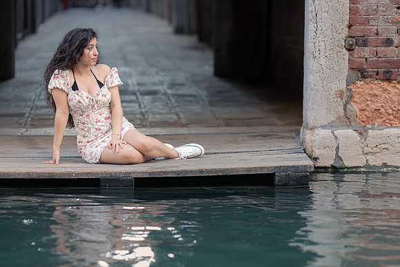 Lady standing by Venice canal