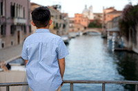 Child admiring the Venice canals during family vacation