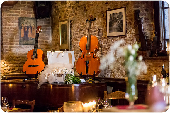 Cozy restaurant with musical instruments displayed during a Venice wedding.