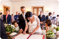 Bride and groom signing their marriage certificate at their Venice wedding.