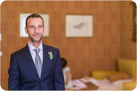 Groom standing and posing in his wedding suit in Venice.
