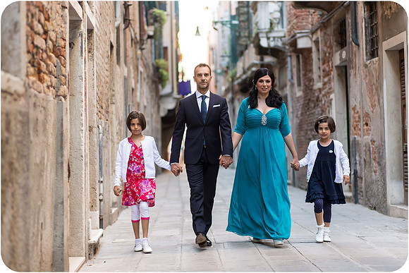 Family walking through the streets of Venice on their wedding day.