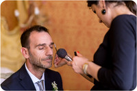Groom receiving final makeup touches before his wedding in Venice.