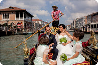 Family riding a gondola on their wedding day in Venice.