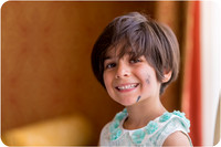 Smiling young girl in a blue dress during a Venice wedding.