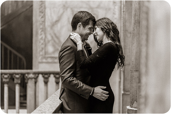 Couple kissing under the grand arches of Venice at night.