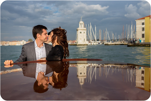 Elegant couple enjoying a romantic water taxi ride in Venice.