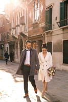 Couple walking sunlit Venice streets