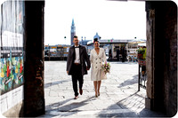 Bride and groom walking Venice streets
