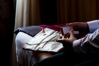 Groom reviewing vows in hotel room