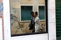 Reflection of bride in Venice alleyway