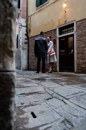 Couple walking cobbled Venice street