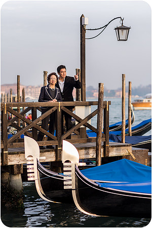 Mother and son walking in St. Mark's Square, Venice.