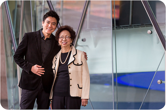 Mother and son in front of Milanese architecture.