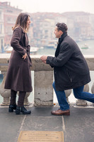 Man proposing to his partner on Rialto Bridge at sunrise.