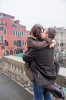 Couple kissing after their engagement at Rialto Bridge.