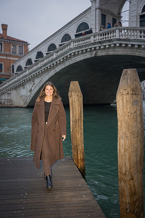 Engaged woman walking near the Grand Canal in Venice.